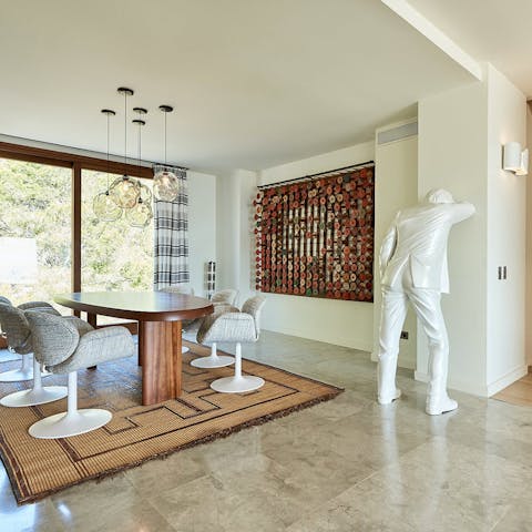 Dine on Charlotte Perriand's Forme Libre table surrounded by the private collection of modern artworks