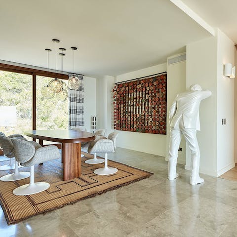 Dine on Charlotte Perriand's Forme Libre table surrounded by the private collection of modern artworks