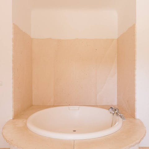 Soak away your cares in the deep circular tub