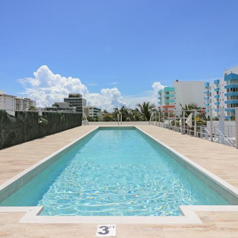 Swim in the shared rooftop pool