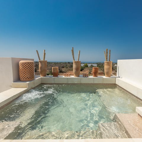 Take in the Ionian Sea views in the distance from the rooftop hot tub