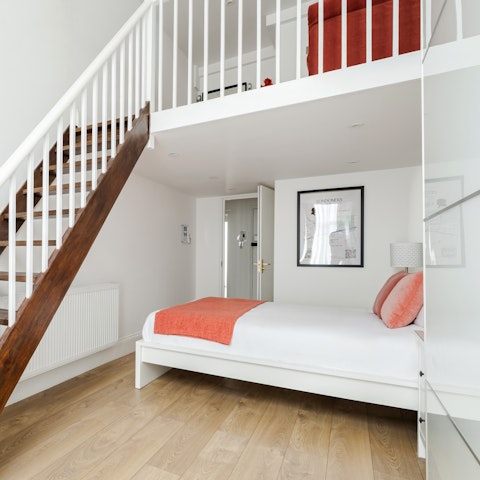 Bunk in with a friend or family in this flexible bedroom with a mezzanine space