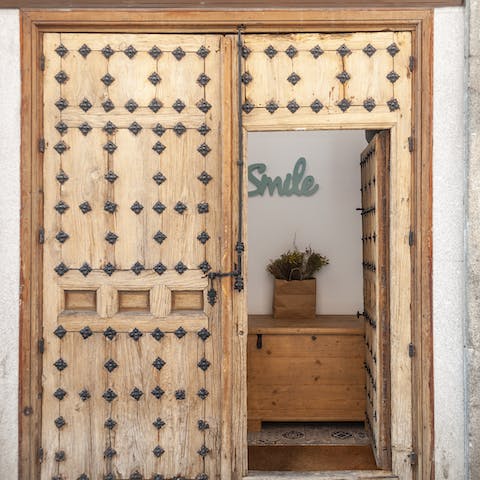 Open up your front door studded with intricate iron rosettes