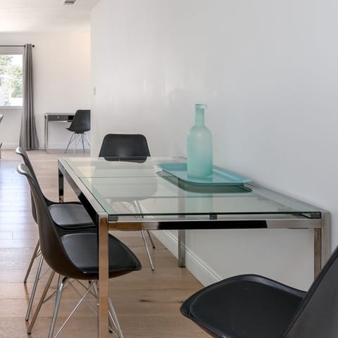 Enjoy breakfast together at the chic glass dining table