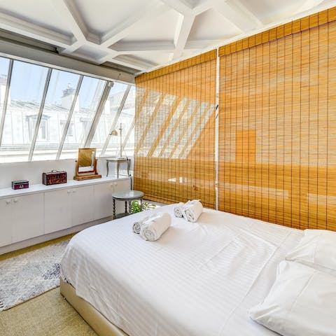 Get a good night's rest in the bedroom located in a traditional Parisian loft