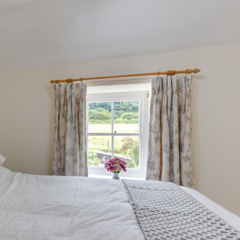 Wake up to pretty green scenes each morning from the king-sized bed