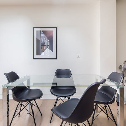 Pour a glass of wine and gather around the glass dining table in the evening