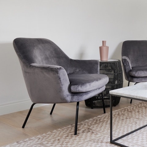 Relax with a novel on the velvet Eames-style armchair