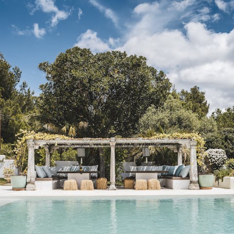 Admire sea views from the comfy seating beside the pool