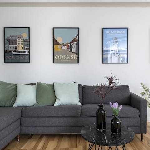 Relax on the stylish Bolia furniture beneath the vintage posters