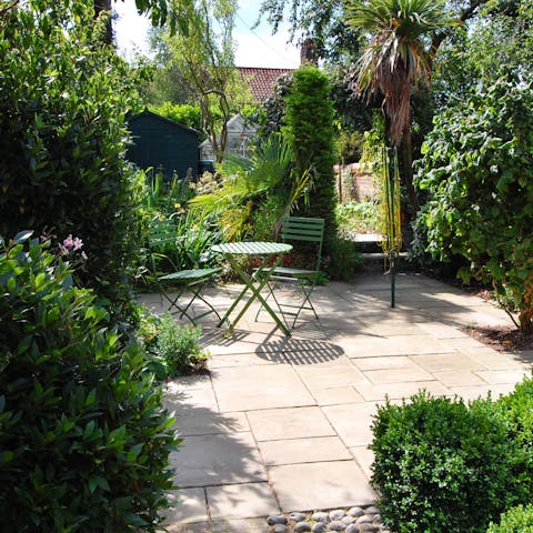 Sip on a warming cup of coffee in the verdant garden