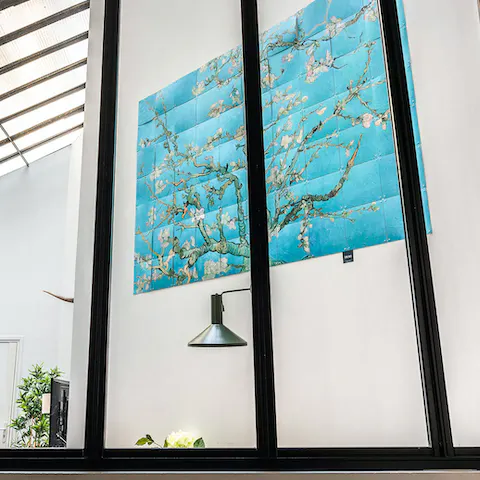 Peer through the bedroom window to the striking blossom artwork in the lounge