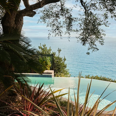 Swim in the pool with the sea spilling out below
