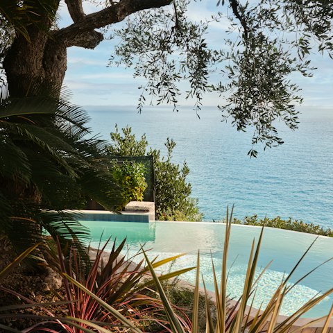 Swim in the pool with the sea spilling out below