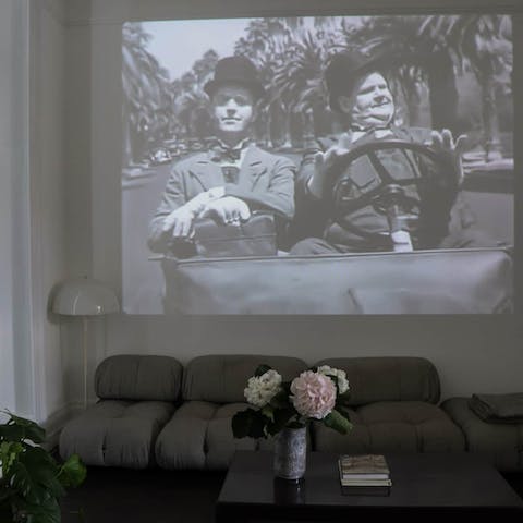 Cuddle up for a movie night like no other with the projector