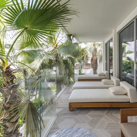 Kick back and crack into that new book on the tranquil balcony shaded by palms