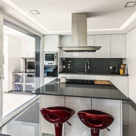 Whip up cocktails at the sleek kitchen bar