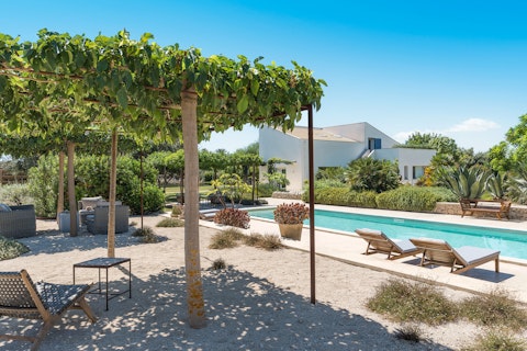 Stretch out poolside beneath a canopy of leaves