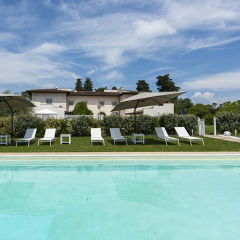 Soak up the sun from the poolside sun loungers