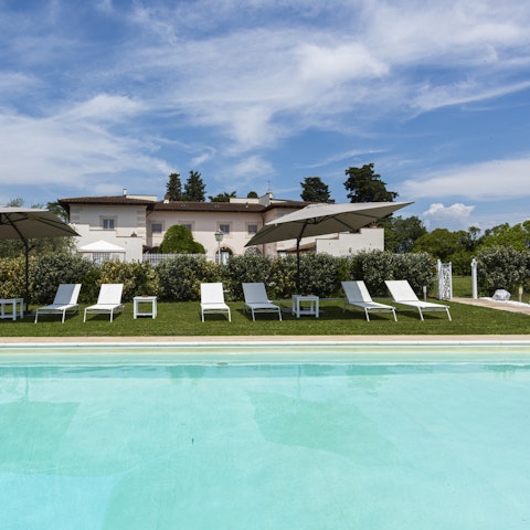 Soak up the sun from the poolside sun loungers