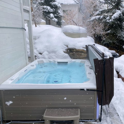 Relax in the hot tub as the snow falls