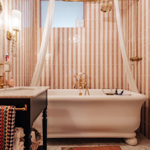 Sink into the roll-top marble bath after a busy day exploring