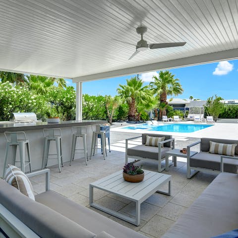 Get creative in the outdoor kitchen and gather together for drinks as the sun sets