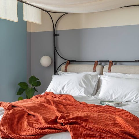 Drift to sleep in a king-size canopy bed