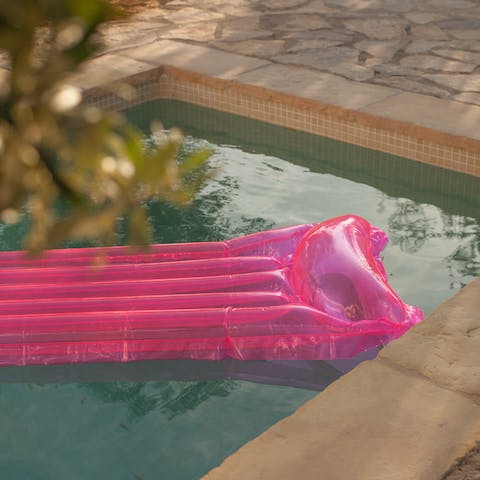 Float in the swimming pool and soak up the sun