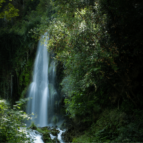 Drive eight minutes to Fonts de les Dous and hike around the waterfalls