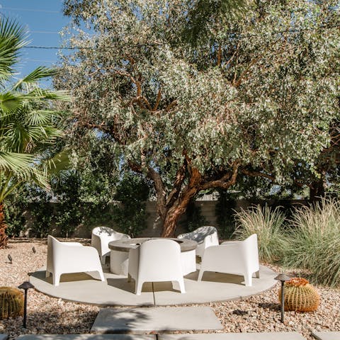 Gather round the fire pit with a glass of wine after dark