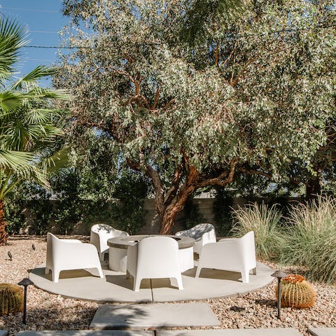 Gather round the fire pit with a glass of wine after dark