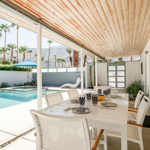 Dine on the poolside terrace as the sun goes down