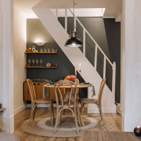 Gather around the chic dining table for a feast of meats, cheeses, and bread