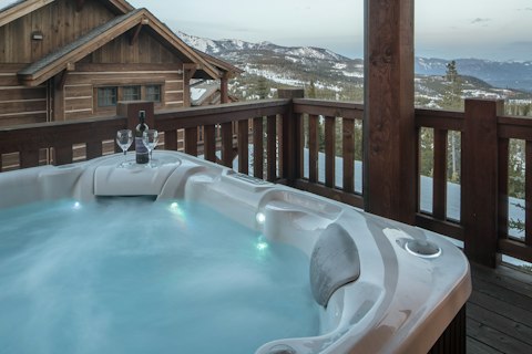 Soak in the outdoor hot tub with snow-dusted mountain peaks ahead