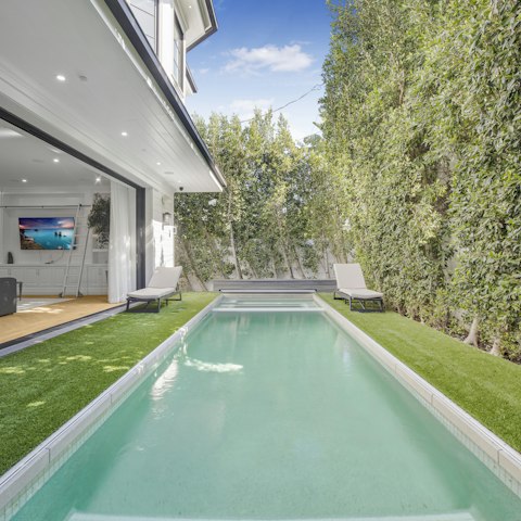 Cool off in the private pool enclosed within a hedged garden