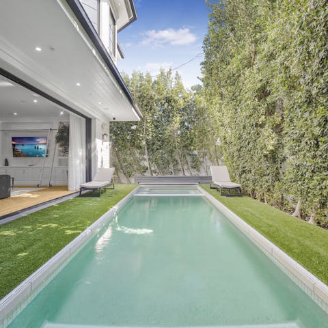 Cool off in the private pool enclosed within a hedged garden