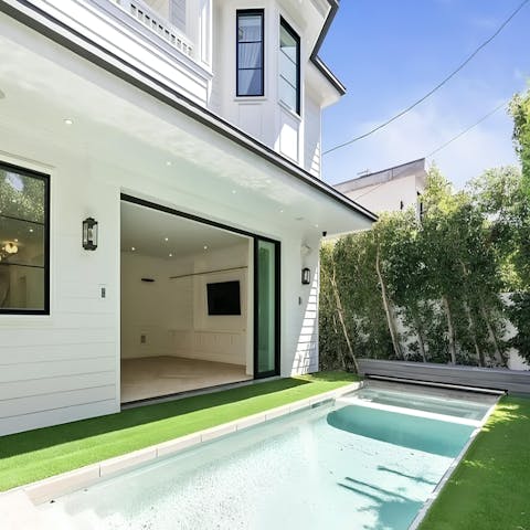 Cool off in the private pool enclosed within a hedged garden