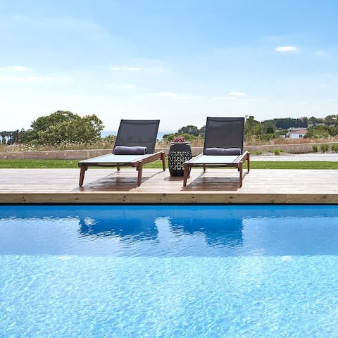 While away afternoons poolside, lounging on the chairs and swimming in the water