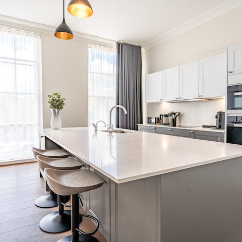 Sip your first morning coffee at the effortlessly chic quartz breakfast bar