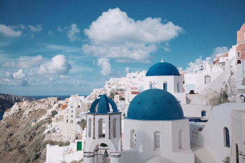 Check out Oia's iconic blue-domed churches, just five minutes on foot