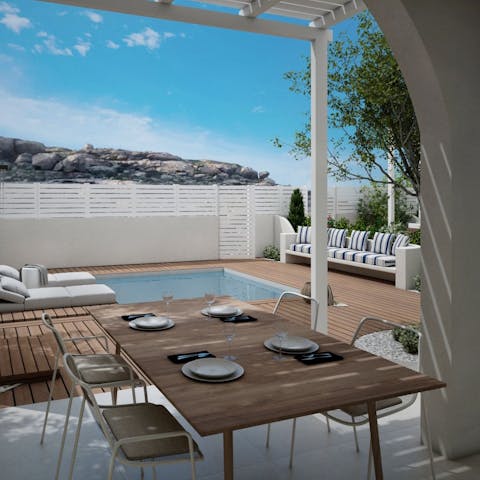 Dine alfresco beneath the pergola and admire views of the island