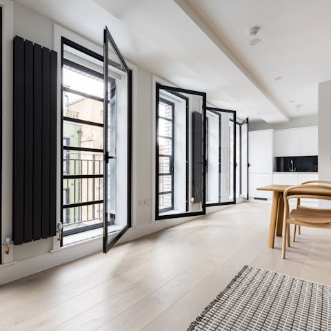 Open up the floor-to-ceiling windows to gaze down at the streets below