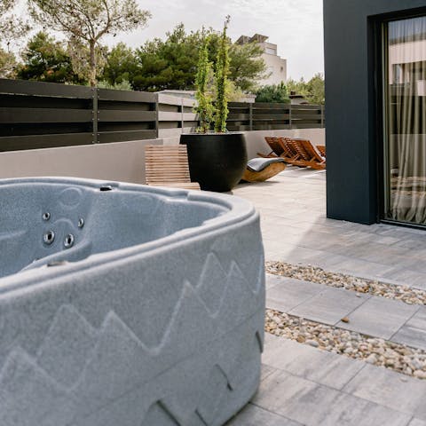 Relax in the hot tub with a glass of local wine