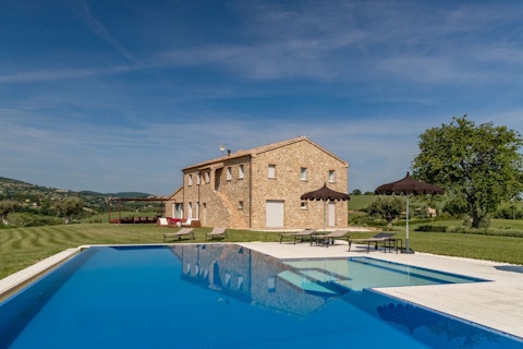 Swim in a private pool framed by rolling Le Marche hills