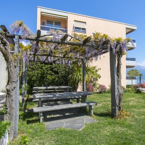 Enjoy meals, drinks, and a game of cards beneath the flower woven pergola
