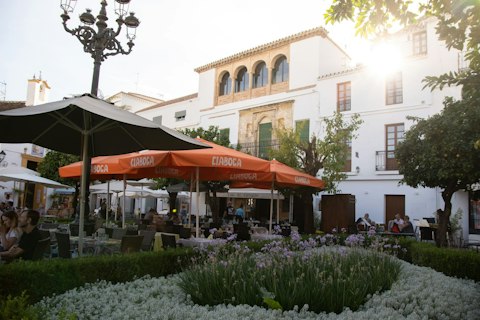 Wander Marbella Old Town's whitewashed alleys, orange trees, and vibrant Plaza de los Naranjos, about thirty-minutes by car