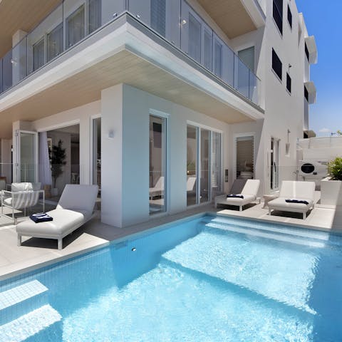 Relax on a lounger by the private pool