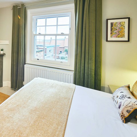 Fall in love with the bedroom windows' glimpse of the sea