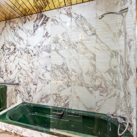 Treat yourself to a long soak in the rather fetching green bathtub